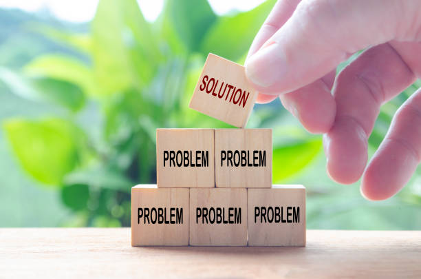 istock Hand putting Solution wooden cube on top of other problematic cubes. Business solution concept 2199361184