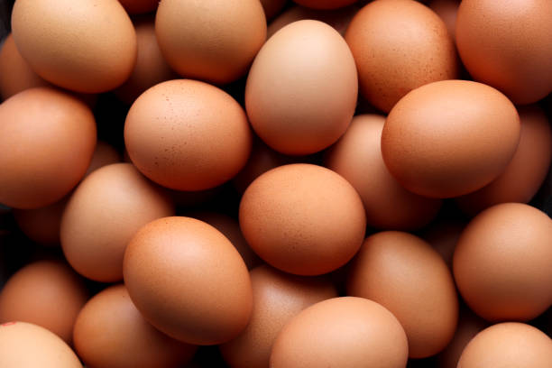 istock Close-up of many chicken brown eggs background. 2199362144