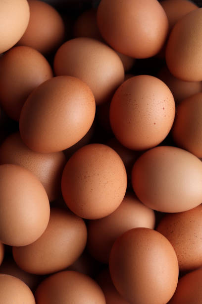 istock Close-up of many chicken brown eggs background. 2199362251