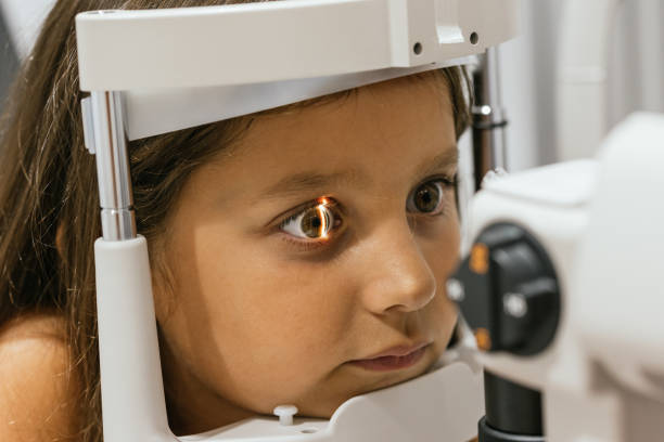 istock Young girl undergoing eye exam with phoropter in modern clinic 2199367893