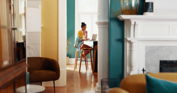 istock Doorway, laptop and thinking with woman in home office for online design or web development. Computer, planning and remote work with freelance employee in apartment for creative career or job 2199374563