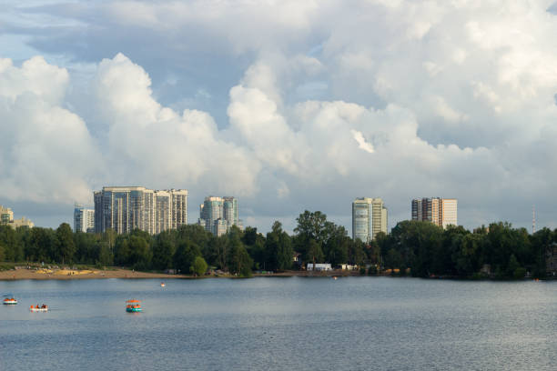 A wooden boat floats in a city lake