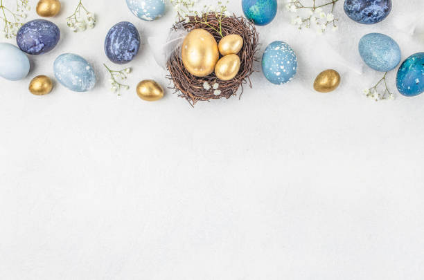 istock Easter eggs with blossoms spring flowers in a nest on a white background. Natural easter greeting card. top view. copy space 2199377283