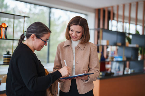 istock real estate agent and customer using digital tablet at the office. 2199377393