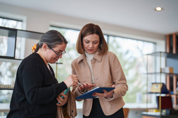 istock real estate agent and customer using digital tablet at the office. 2199377394