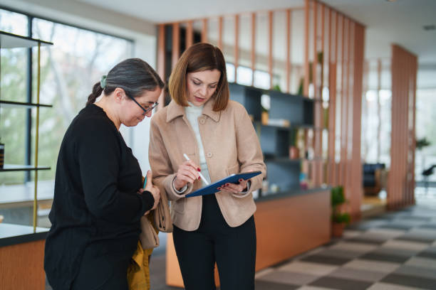 istock real estate agent and customer using digital tablet at the office. 2199377398