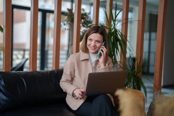 istock Businesswoman using laptop and mobile phone at the office 2199377775