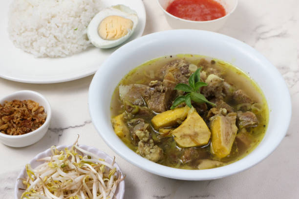 istock Delicious Indonesian Sop Buntut: A savory beef tail soup, served with rice, boiled egg, bean sprouts, and crispy fried shallots. 2199378221