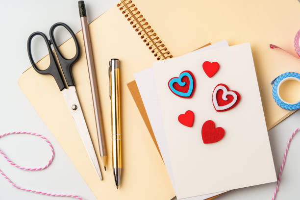 istock Creative workspace for making handmade greeting cards with colorful hearts and stationery 2199378477
