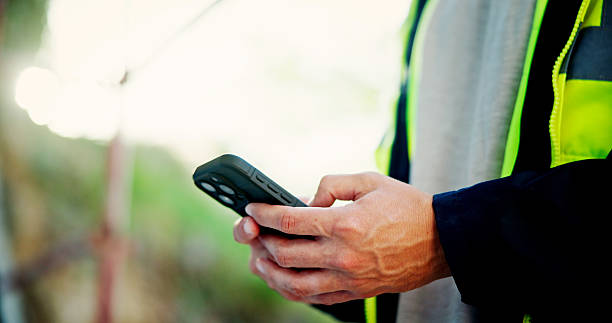 istock Cellphone, hands and man outdoor with communication, networking or contact online with mobile app. Technology, closeup and male engineer typing text, email or blog on social media with phone. 2199378841