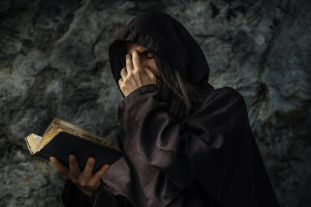 istock Man in Robe with Holy Bible 2199379529