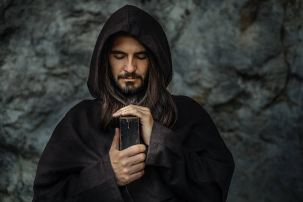 istock Man in Robe with Holy Bible 2199379542
