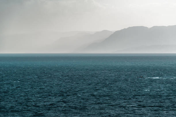 Beautiful seascape fog and mountains before storm