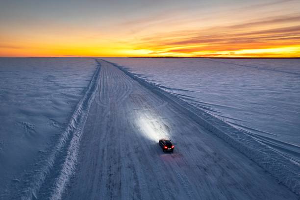 Car traveling empty road in winter