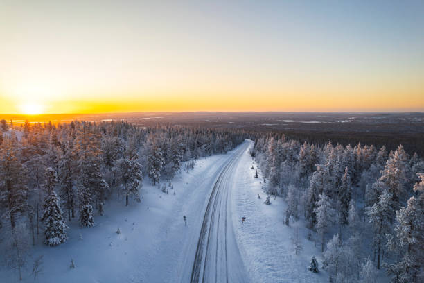 istock Empty road in the winter forest at sunrise 2199383971