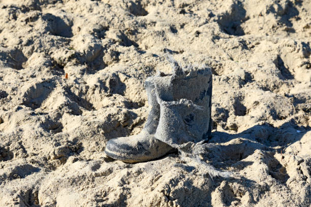 A destroyed shoe lies on a sandy beach on the coast of the Baltic Sea in the city of Sopot, Poland.