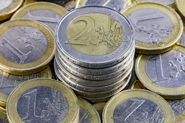 istock Coins denominated in euro are lying in a pile 2199385562