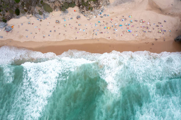 istock Ocean beach with turquoise waters and tourists relaxing on sandy seashore 2199386603