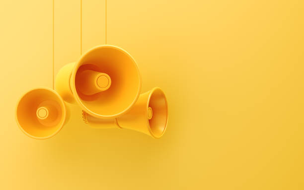 istock Yellow Megaphones Hanging from a Yellow Background 2199388093