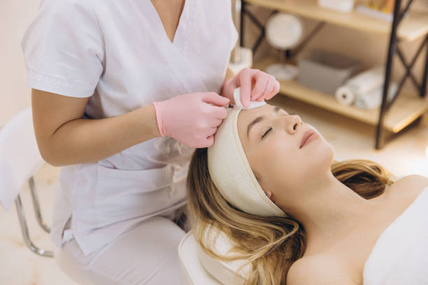 istock Cosmetologist performing rejuvenating injections on a client's forehead in a clean and serene beauty salon environment 2199393110