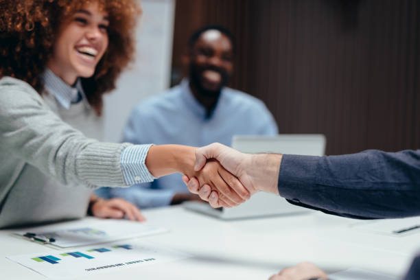 istock Business people shaking hands over a meeting table 2199394921