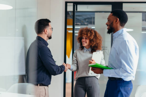 istock Business people shaking hands in modern office after successful meeting 2199395053