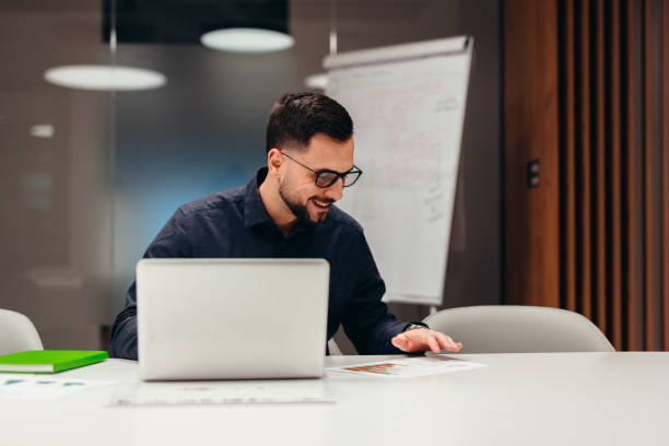 istock Businessman analyzing financial charts and working on laptop in modern office 2199395078