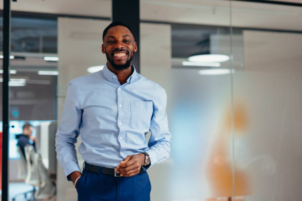 istock Confident young businessman smiling in modern office 2199395231