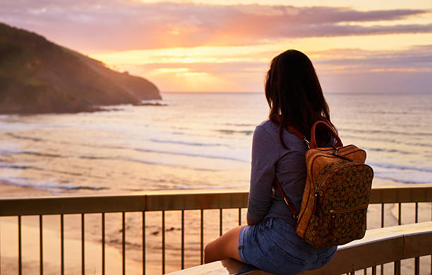 istock woman sunset coast line view 2199396805