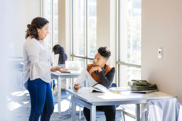 istock Teacher and Student Talking in College Library 2199398202