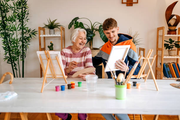 istock Enjoying spending time with older people and talking to them while painting together 2199398719