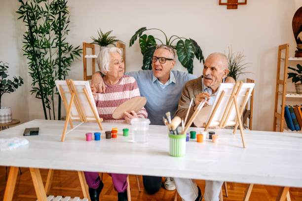 istock Enjoying spending time with older people and talking to them while painting together 2199398772