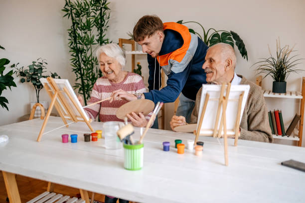 istock Enjoying spending time with older people and talking to them while painting together 2199398813