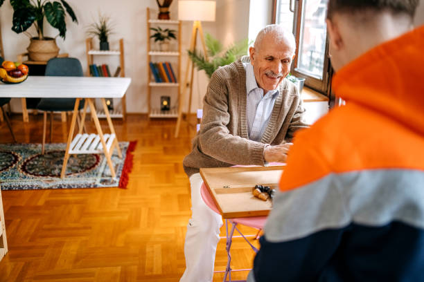 istock Enjoying spending time with older people and talking to them while playing chess game 2199399239