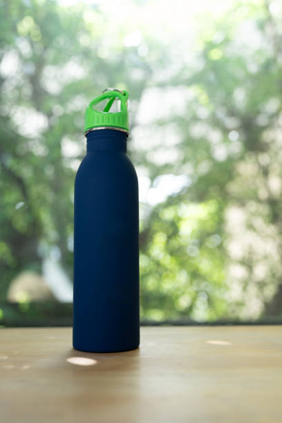 istock Blue water bottle stands tall against a nature background 2199399672