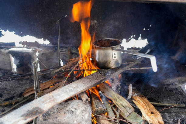 Coffee on a fire in a jezve, coffee, campfire, barbecue, mountains, forest, winter