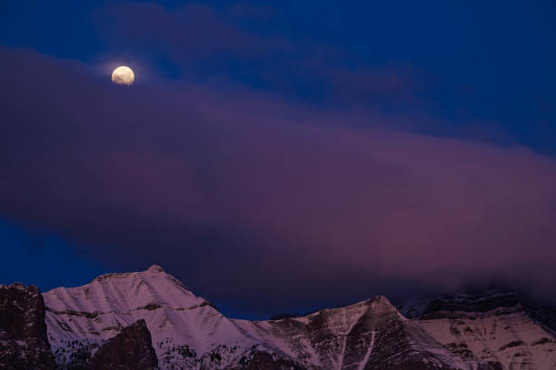 The Wolf Moon sets over Mount Rundle in Banff National Park near Banff, Alberta, Canada, in January. The Wolf Moon is the first full moon of the calendar year.