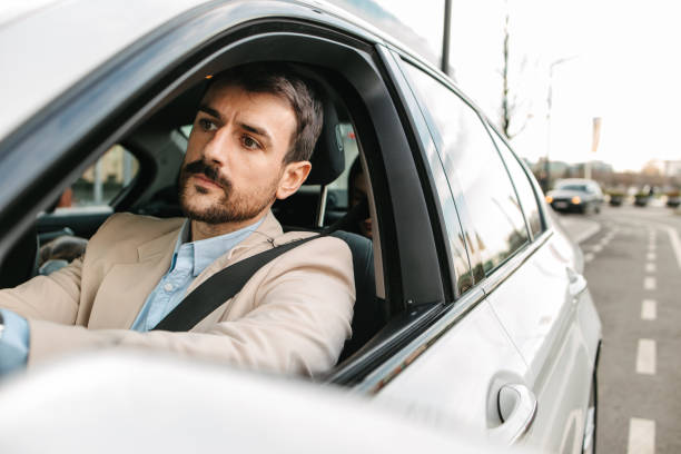 istock Young businessman driving a car 2199400591