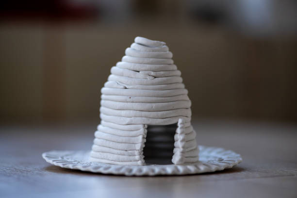 Close-up on a small house made of clay. Homemade clay objects.