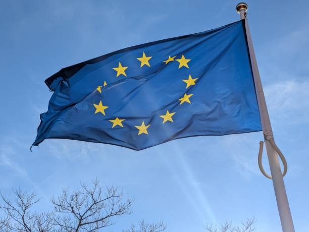 istock a European flag in the middle of a blue sky 2199401645