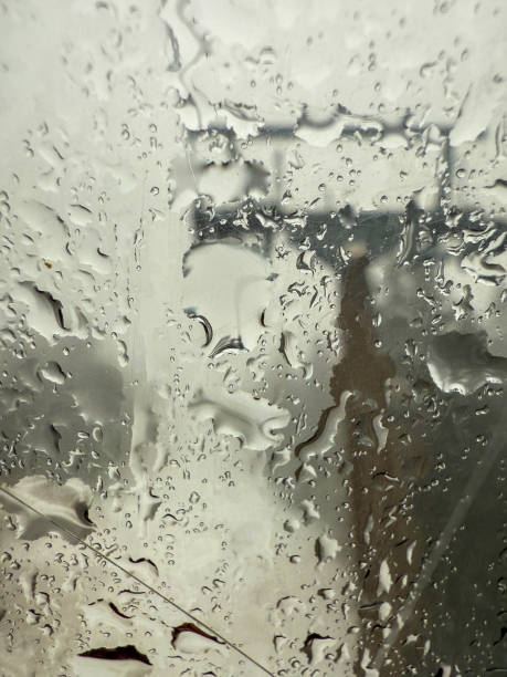 istock Blurry View of a Ski Lift Through a Rain-Soaked Window 2199402845