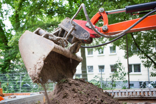 istock Excavator bucket filled with dirt 2199403175