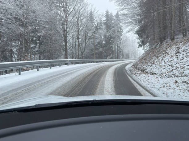 istock Snowy Winding Road View from Inside a Car 2199403737