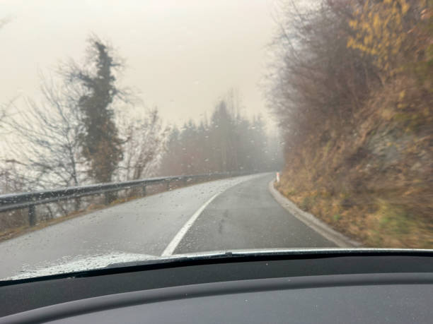 istock Driving Through a Foggy Mountain Road – POV Perspective 2199404203