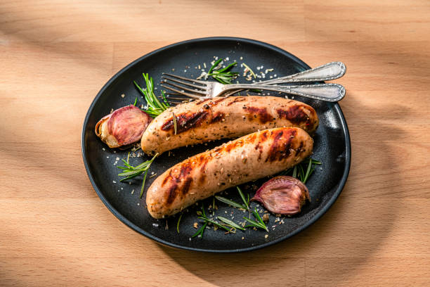 istock Two grilled sausages ready to eat served in a black plate 2199404720