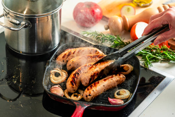istock Cooking German Bratwurst sausages in a grill pan 2199404779
