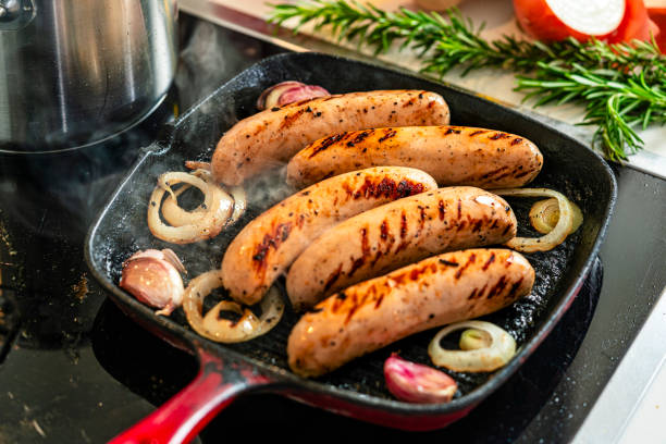 istock Cooking German Bratwurst sausages in a grill pan 2199404814