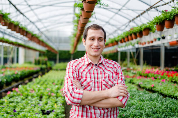 istock farmer man portrait in a green house 2199407714