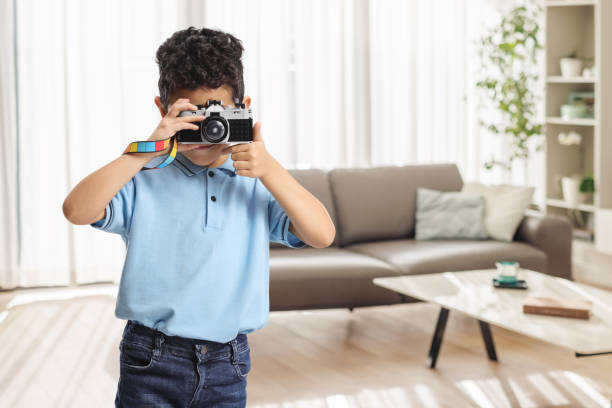Kid taking a photo with a toy camera at home