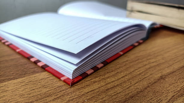 istock sheets of paper in a red book on the table 2199409390